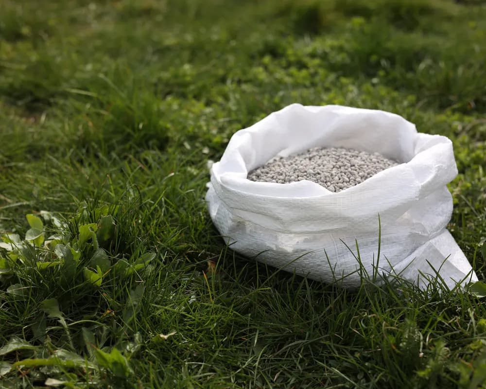 Bag of potassium fertiliser on green grass