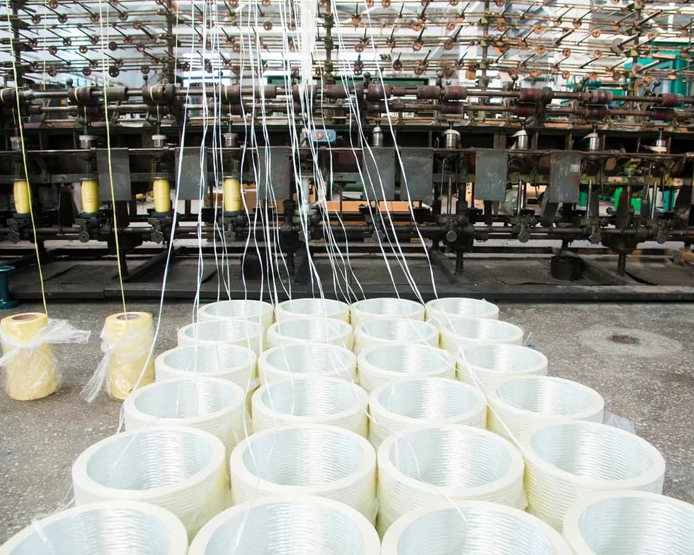 Polyester filament yarn spools in a textile factory
